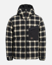 Man wearing The Mountain Studio D-1 RCH reversible down check jacket in Black Onyx, a 750 fill power down jacket with helmet-compatible storm hood, styled for winter. thumbnail image