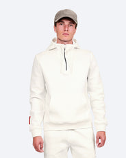 The Mountain Studio H-9 Cotton Tech Hood Half Zip in White Alyssum, on model front, styled with a cap thumbnail image