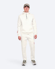 The Mountain Studio H-9 Cotton Tech Hood Half Zip and J-14 Cotton Tech Pants in White Alyssum, on model front thumbnail image