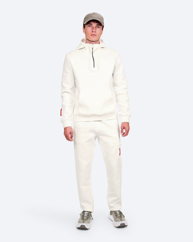 The Mountain Studio H-9 Cotton Tech Hood Half Zip and J-14 Cotton Tech Pants in White Alyssum, on model front