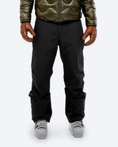 The Mountain Studio P-3 ALP-3 Stretch 3L Insulated Carv Pants in Black Onyx, on model front, styled with quilted jacket