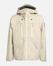 Light beige Z-2 EPE shell jacket by The Mountain Studio with a helmet-compatible hood, white waterproof zippers, deep chest and hand pockets, and minimalist alpine design in PFAS-free Gore-Tex ePE 3-layer fabric.