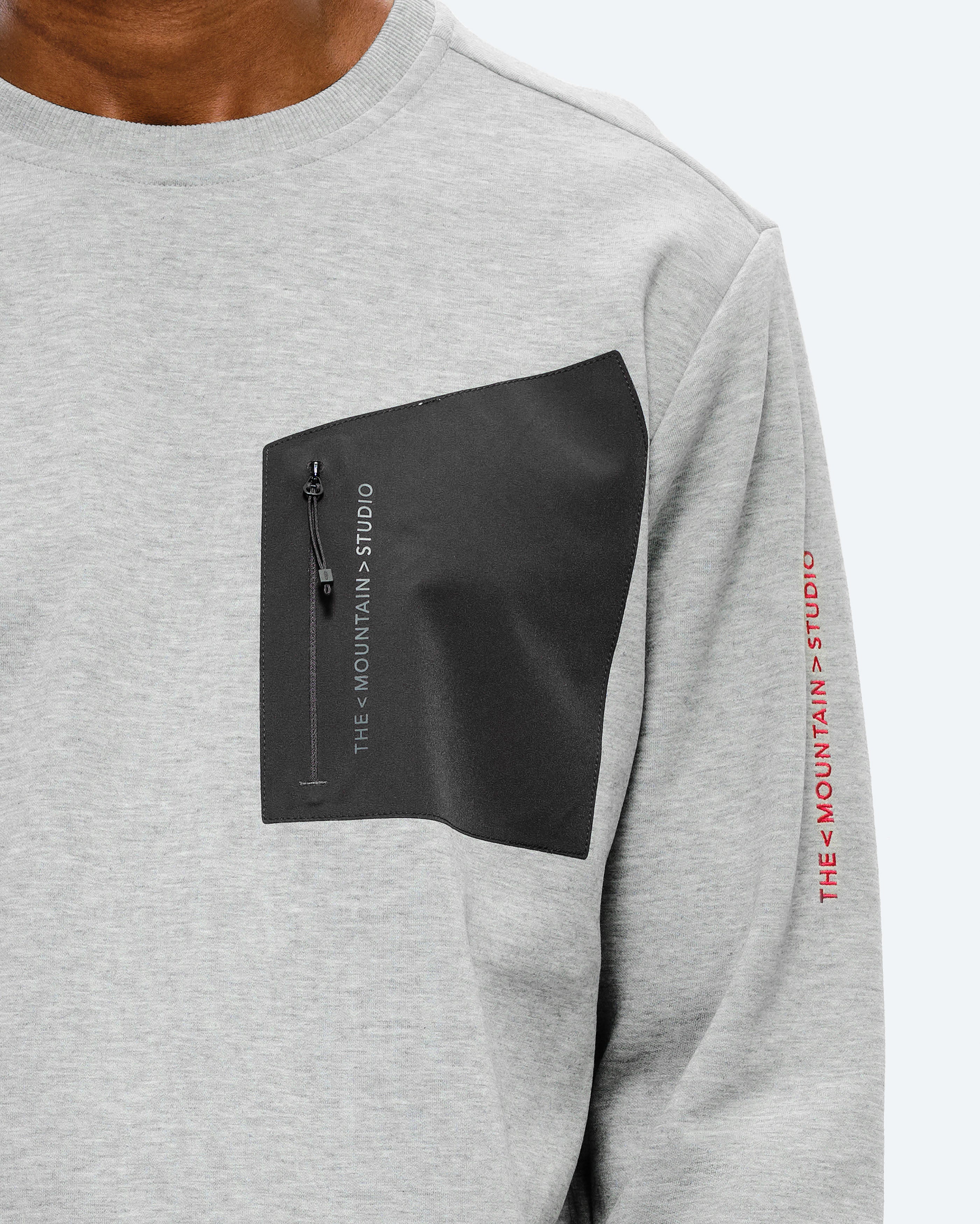 Bonded signature chest pocket in softshell stretch with zip. card image